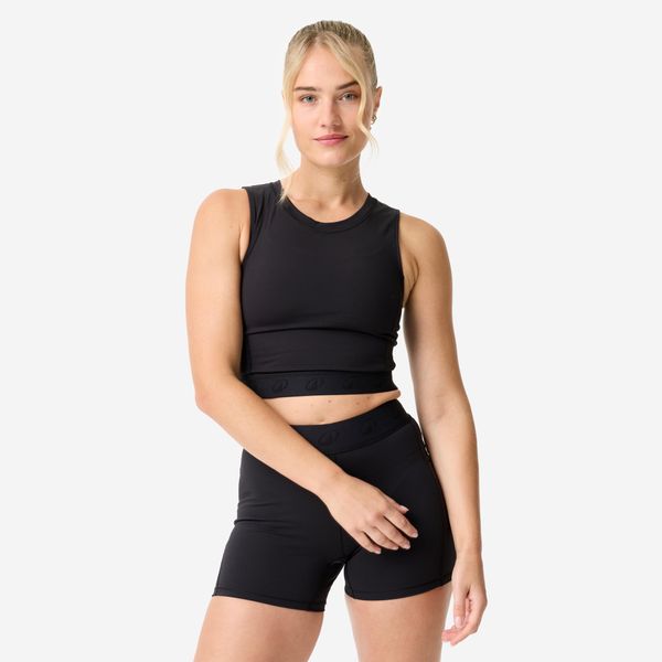 Koszulka fitness damska Domyos crop top. Czarne bluzki sportowe damskie DOMYOS, l, z elastanu, bez kołnierzyka, bez ramiączek. Za 69.99 zł.