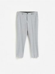 Spodnie garniturowe slim fit - jasnoszary. Szare spodnie wizytowe męskie Reserved, z tkaniny. Za 169.99 zł.