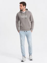 Męskie spodnie jeansowe JOGGERY z przetarciami - jasnoniebieskie V1 OM-PADJ-0150 - XXL. Niebieskie spodnie materiałowe męskie Ombre Clothing, bez wzorów, z bawełny. W wyprzedaży za 69.99 zł.