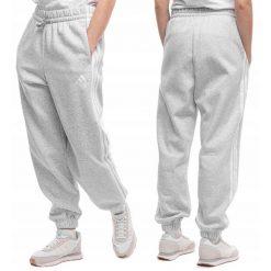 Damskie spodnie dresowe adidas Essentials 3-Stripes Fleece Loose-Fit. Szare spodnie sportowe damskie Adidas, z bawełny, na fitness i siłownię. Za 178.99 zł.
