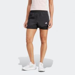 Spodenki fitness damskie ADIDAS 2 w 1. Spodenki sportowe damskie Adidas, bez wzorów, z materiału, sportowe. W wyprzedaży za 119.99 zł.