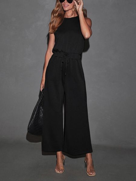 Milan Kiss Kombinezon w kolorze czarnym rozmiar: M. Czarne kombinezony damskie Milan Kiss, m, bez wzorów, bez kołnierzyka, bez ramiączek. Za 196.24 zł.