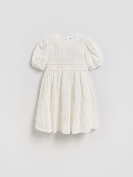 Sukienka z cekinami - złamana biel. Sukienki dziewczęce Reserved, bez wzorów, z bawełny, bez ramiączek. Za 129.99 zł.