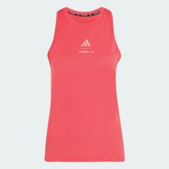 Koszulka bez rękawów z grafiką Les Mills. Czerwone bluzki sportowe damskie Adidas, l, z materiału, bez kołnierzyka, bez ramiączek. Za 179.00 zł.