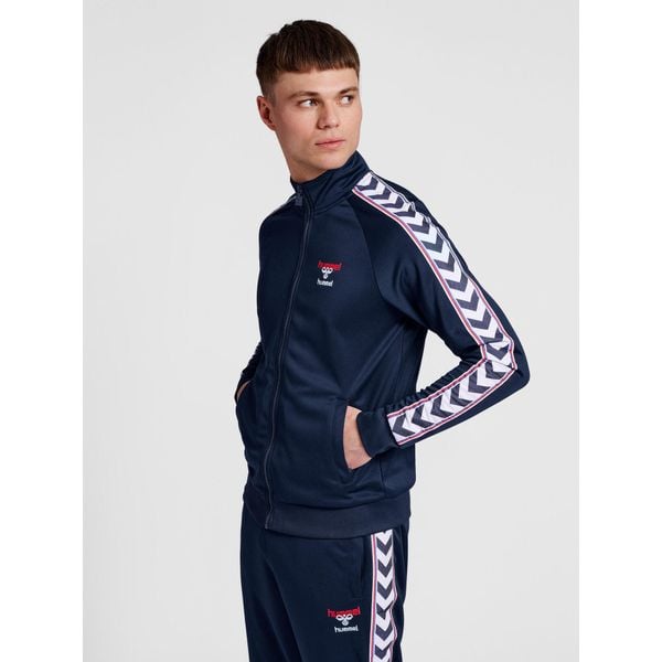 Bluza dresowa zapinana na zamek błyskawiczny Hummel IC Lerby Poly. Niebieskie bluzy sportowe damskie HUMMEL, xs, bez wzorów, z dresówki, bez ramiączek, bez kaptura. Za 299.00 zł.