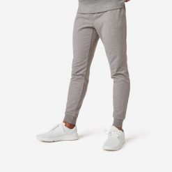 Spodnie dresowe męskie Nyamba Gym & Pilates 500 slim. Czarne spodnie sportowe męskie DOMYOS, z bawełny. W wyprzedaży za 69.99 zł.