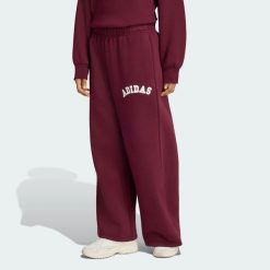 Damskie spodnie adidas z 3 paskami. Czerwone spodnie materiałowe damskie Adidas, bez wzorów, z bawełny. Za 239.00 zł.