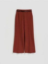 Spodnie z paskiem - miedziany. Brązowe spodnie materiałowe damskie Reserved, bez wzorów, z tkaniny. Za 159.99 zł.