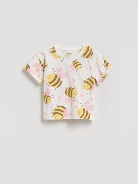 Bawełniany t-shirt we wzory - złamana biel. Koszulki dziewczęce Reserved, m, bez wzorów, z bawełny, bez ramiączek. Za 25.99 zł.