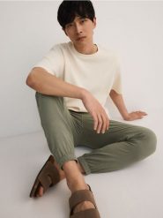 Spodnie joggery z lnem - ciemnozielony. Zielone spodnie materiałowe męskie Reserved, bez wzorów, z wiskozy. W wyprzedaży za 119.99 zł.