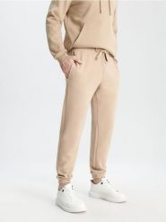 Spodnie dresowe jogger - beżowy. Brązowe spodnie sportowe męskie Sinsay, z bawełny. Za 29.99 zł.