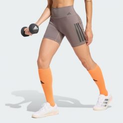 Krótkie legginsy Optime Workout 3-Stripes. Brązowe legginsy sportowe damskie Adidas, bez wzorów, z lycry, z podwyższonym stanem, na fitness i siłownię. Za 199.00 zł.