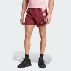 Szorty Own the Run 3-Stripes. Czerwone szorty męskie Adidas, bez wzorów, z materiału, sportowe. Za 229.00 zł.