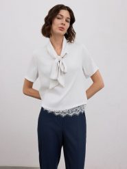 BGN Bluzka w kolorze białym rozmiar: 40. Białe bluzki damskie BGN, bez wzorów, z koronki, bez kołnierzyka, bez ramiączek. Za 91.56 zł.