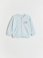 Bluza bomber Psi Patrol - jasnoniebieski. Niebieskie bluzy i bluzki niemowlęce Reserved, bez wzorów, z bawełny, bez ramiączek, bez kaptura. W wyprzedaży za 35.99 zł.