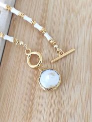 Nakkash Pozłacany naszyjnik perłą i masą perłową - dł. 45 cm rozmiar: onesize. Białe naszyjniki damskie Nakkash, pozłacane. Za 39.99 zł.