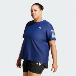Koszulka Own The Run (Plus Size). Białe bluzki damskie Adidas, plus size, z materiału, bez kołnierzyka, bez ramiączek. Za 159.00 zł.