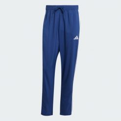 Spodnie Essentials 3-Stripes Stanford Open Hem. Białe spodnie sportowe męskie Adidas, z materiału. Za 179.00 zł.