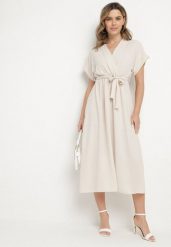 Jasnobeżowa Sukienka o Rozkloszowanym Kroju z Wiązanym Paskiem Sepelina. Brązowe sukienki damskie Born2be, na co dzień, na lato, s, bez wzorów, eleganckie, bez kołnierzyka, bez ramiączek, maxi, kopertowe. W wyprzedaży za 67.99 zł.