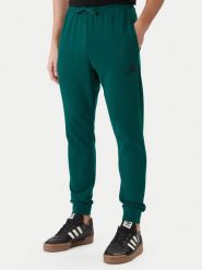Adidas Spodnie dresowe Essentials Feel Cozy JE3858 Zielony Regular Fit. Zielone spodnie dresowe męskie Adidas, bez wzorów, z bawełny. Za 219.99 zł.