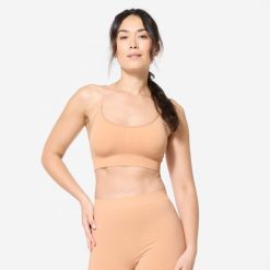 Stanik sportowy Decathlon. Białe biustonosze sportowe damskie STAREVER, bez wzorów, z elastanu. Za 59.99 zł.
