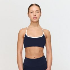 Biustonosz sportowy damski fitness niebieski Varsity. Niebieskie biustonosze sportowe damskie GYMBEAM, bez wzorów, z elastanu. Za 84.90 zł.