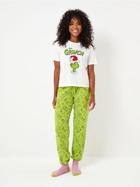 Bawełniana piżama dwuczęściowa z nadrukiem Grinch - kremowy. Białe piżamy damskie Sinsay, l, bez wzorów, z bawełny, bez ramiączek. W wyprzedaży za 29.99 zł.