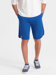 Szorty męskie dresowe z zaokrągloną nogawką - niebieskie V1. Niebieskie szorty męskie Ombre Clothing, bez wzorów, z bawełny, sportowe. W wyprzedaży za 39.99 zł.