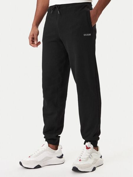 Guess Spodnie dresowe Z6RB12 KAIJ1 Czarny Regular Fit. Czarne spodnie dresowe męskie Guess, z aplikacjami, z bawełny. Za 239.99 zł.