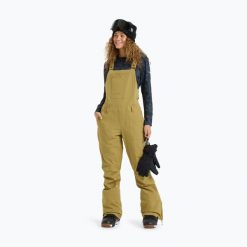 Spodnie snowboardowe damskie ROXY Rideout Bib. Brązowe spodnie materiałowe damskie Roxy, bez wzorów, z materiału, z podwyższonym stanem. Za 1,166.95 zł.