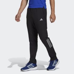 Spodnie Own the Run Astro Knit. Czarne spodnie sportowe męskie Adidas. Za 299.00 zł.