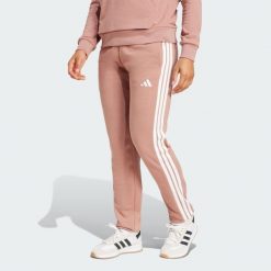 Spodnie Essentials 3-Stripes French Terry Cuffed. Białe spodnie sportowe damskie Adidas, s, z materiału, na fitness i siłownię. W wyprzedaży za 127.02 zł.