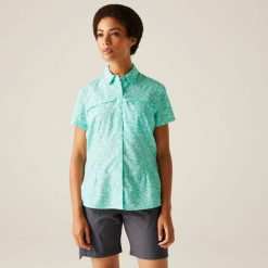 Travel Packaway damska koszula z krótkim rękawem. Białe koszule damskie Regatta, bez wzorów, eleganckie, bez kołnierzyka, bez ramiączek. W wyprzedaży za 150.95 zł.