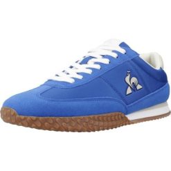 Buty LE COQ SPORTIF VELOCE I Niebieski. Niebieskie buty trekkingowe męskie Le Coq Sportif, ze skóry, bez zapięcia, trekkingowe. Za 316.99 zł.