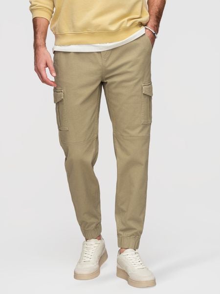 Spodnie męskie JOGGERY z zapinanymi kieszeniami cargo - khaki V1 - Rozmiar: L. Zielone spodnie materiałowe męskie Ombre Clothing, bez wzorów, z bawełny, biznesowe. W wyprzedaży za 129.99 zł.