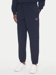 Calvin Klein Jeans Spodnie dresowe Monologo LV047B235G Granatowy Regular Fit. Niebieskie jeansy damskie Calvin Klein Jeans, m, bez wzorów, z bawełny. Za 329.99 zł.