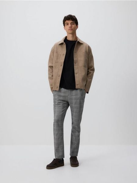 Spodnie slim fit w kratę - jasnoszary. Szare spodnie materiałowe męskie Reserved, bez wzorów, z bawełny. Za 149.99 zł.