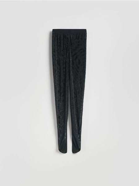 Legginsy z ozdobną aplikacją - czarny. Czarne legginsy damskie Reserved, l, z aplikacjami, z dzianiny. Za 199.99 zł.
