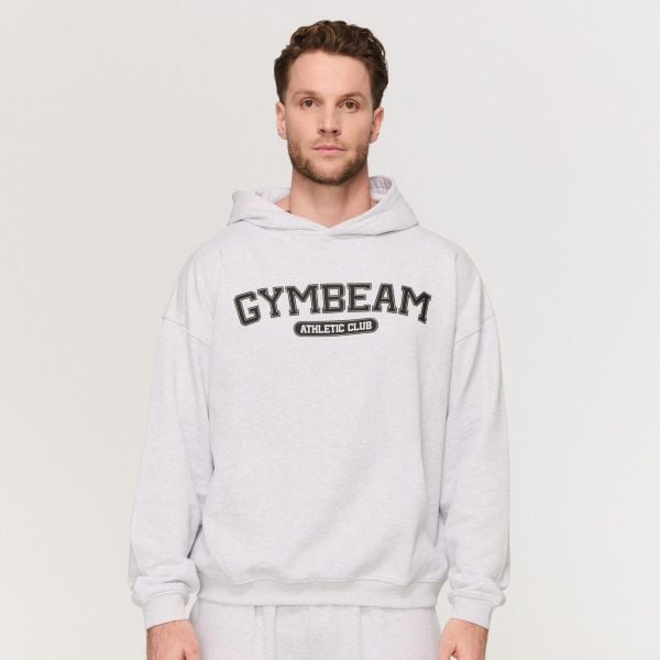 Bluza męska fitness z kapturem oversize Varsity. Szare bluzy sportowe męskie GYMBEAM, bez wzorów, z bawełny, klasyczne, bez kołnierzyka, bez ramiączek. Za 142.90 zł.