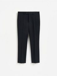 Spodnie garniturowe slim fit - granatowy. Niebieskie spodnie wizytowe męskie Reserved, z tkaniny. Za 169.99 zł.