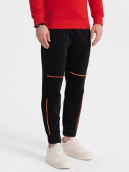 Spodnie męskie dresowe z kontrastowymi przeszyciami - czarne V1. Czarne spodnie dresowe męskie Ombre Clothing, bez wzorów, z bawełny. W wyprzedaży za 69.99 zł.