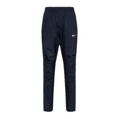 Spodnie do biegania damskie Nike Woven. Niebieskie spodnie materiałowe damskie Nike, bez wzorów, sportowe. Za 99.99 zł.