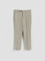 Spodnie garniturowe slim fit - oliwkowy. Zielone spodnie wizytowe męskie Reserved, z tkaniny. Za 169.99 zł.