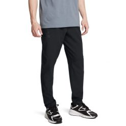 Under Armour SPORTSWEAR WVN TAPER PANT Spodnie męskie. Czarne spodnie materiałowe męskie Under Armour, bez wzorów, z elastanu, sportowe. Za 269.99 zł.
