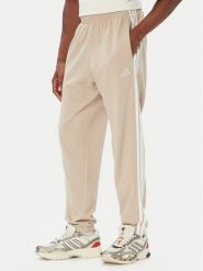 Adidas Spodnie dresowe Essentials 3-Stripes French Terry Tapered Cuffed KY4196 Beżowy Regular Fit. Brązowe spodnie dresowe męskie Adidas, bez wzorów, z bawełny. Za 219.99 zł.