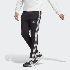 Essentials Single Jersey Tapered Open Hem 3-Stripes Pants. Białe spodnie dresowe męskie Adidas, bez wzorów, z dresówki. Za 159.00 zł.