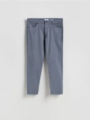 Bawełniane spodnie slim fit - granatowy. Niebieskie spodnie materiałowe męskie Reserved, bez wzorów, z bawełny. Za 149.99 zł.