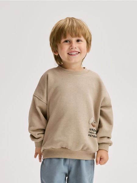 Bawełniana bluza - brązowy. Brązowe bluzy i bluzki niemowlęce Reserved, bez wzorów, z bawełny, bez ramiączek, bez kaptura. W wyprzedaży za 27.99 zł.