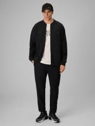4F Spodnie casual męskie 4F x Robert Lewandowski - czarne L. Czarne spodnie materiałowe męskie 4f, bez wzorów, z tkaniny, biznesowe. Za 229.99 zł.