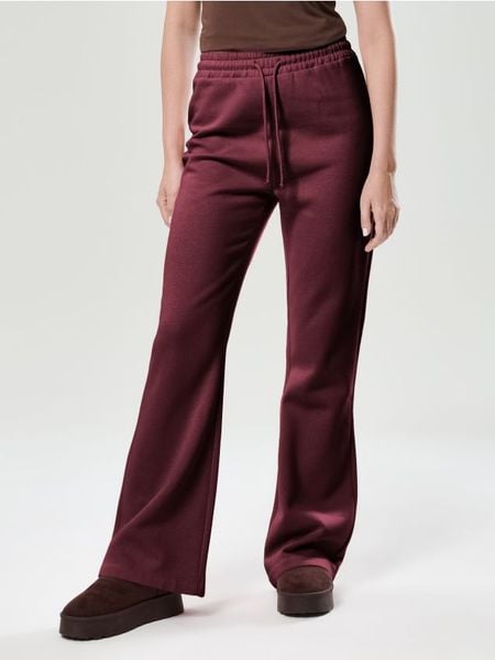 Spodnie flare - bordowy. Czerwone spodnie materiałowe damskie Sinsay, bez wzorów. Za 17.99 zł.